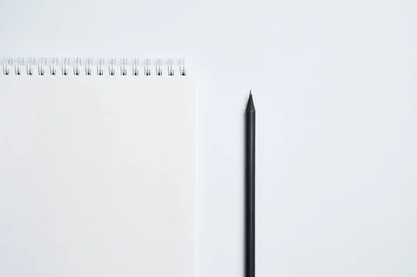 white office Desk top view with Notepad,and pencil,minimalistic design, top view,copy space,flat lay