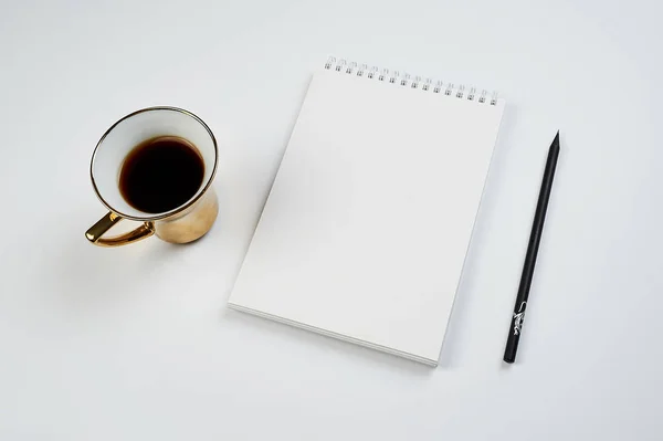 White office Desk top view with Notepad, pencil and coffee Cup, minimalistic design, top view,copy space,flat lay — Stock Photo, Image