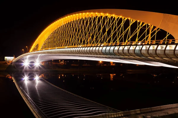 Modern Troja tram bridge over Vltava river in Prague at night