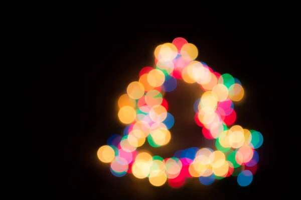 Vánoční věnce s barevnými světly ve tvaru křtu — Stock fotografie