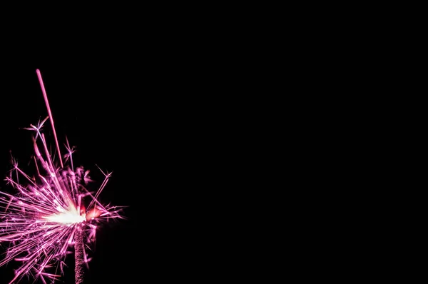 Sparkler in pink and white light on a black background. — Stock Photo, Image