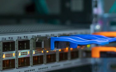 Network switch. Modern network switch speed 40 - 100 Gigabit Ethernet ports. Closeup of optical module at data center of the internet provider. Internet network communication. clipart