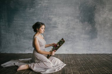 Pembe Elbiseli Kız Gri Arkaplanda Taze Çiçeklere Bakar