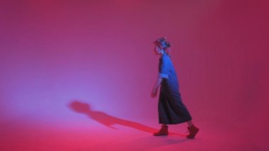 Stüdyoda renkli neon bir arka planda dans eden zarif genç bir kız. Müzik dj poster tasarımı.