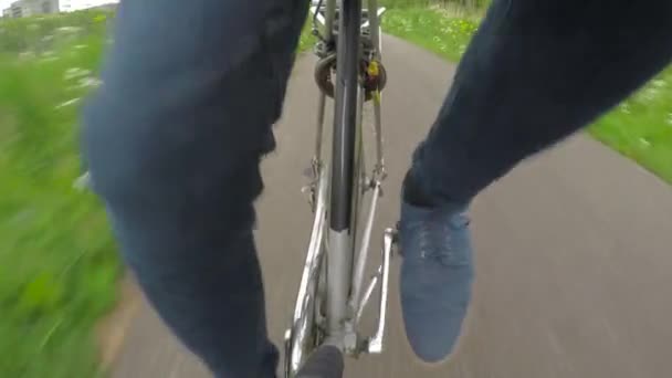 Cycling cyclist wheels legs pedal in nature urban bicycle path outdoors, front. — Stock Video