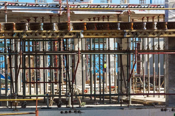 Lavoratori che lavorano tra ponteggi e calcestruzzo sul calcestruzzo — Foto Stock