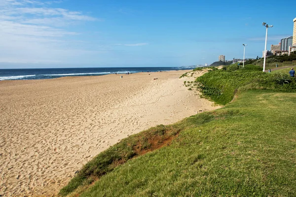 Grünstreifen und Strand gegen Gewerbe- und Wohngebäude — Stockfoto