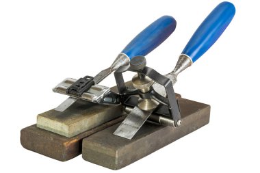Chisels Clamped in Angle Guide Jigs on Grinding Whetstones clipart
