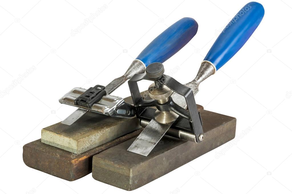 Chisels Clamped in Angle Guide Jigs on Grinding Whetstones