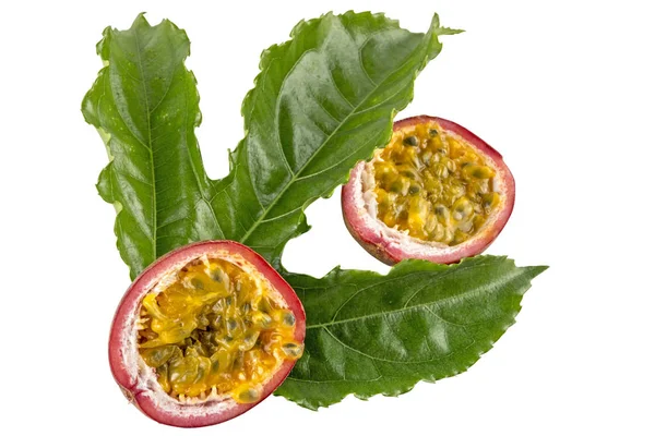 Halves of Red  Passion Fruits and  Green Leaves — Stock Photo, Image