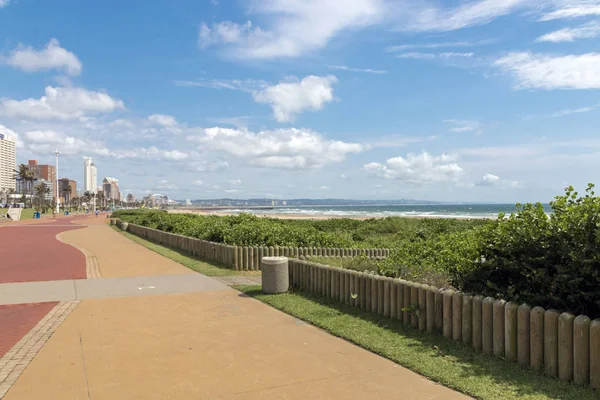 Paseo pavimentado vacío contra el horizonte de la ciudad costera —  Fotos de Stock