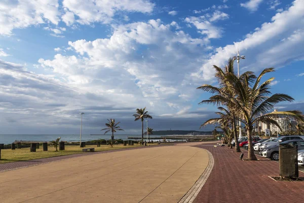 Paseo pavimentado contra el paisaje costero y el cielo azul nublado —  Fotos de Stock