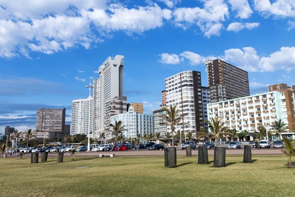 Strandpromenaden mot palmer och strandnära grumlig stadssilhuetten — Stockfoto