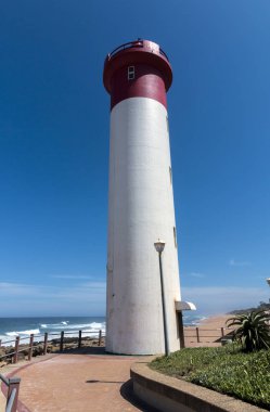 Dikey kırmızı ve beyaz deniz feneri kıyı manzara