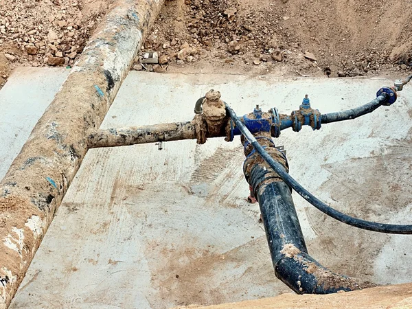Kazı çukuru. Eski 500mm içecek su boru 150mm viraj kolu ile gate vanalar, aşınmış bağlantı parçaları katılmadan. Tüpler onarım boru önce. Asfalt yalıtım. 
