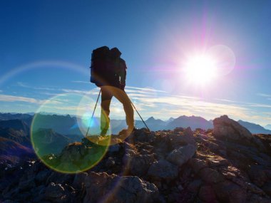 Lens flare kusur. Başlık, sırt çantası ve Polonyalılar elinde olan adam silüeti. Adam yürüyüş