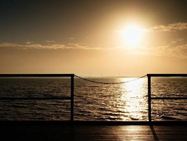 L'alba sull'oceano. Molo di legno vuoto a bella mattina colorata. Pontile turistico — Foto Stock
