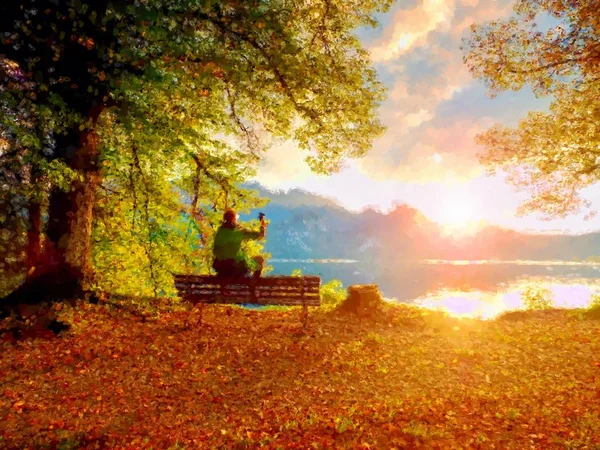 Watercolor paint. Alone man sit on bench at azure mountain lake. — Stock Photo, Image