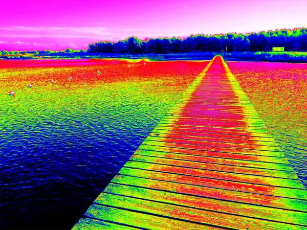 Infrared  photo. Empty wooden mole on sea — Stock Photo, Image