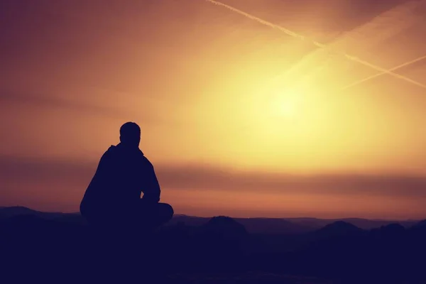 Hiker in black sit alone on summit. Wonderful mountains — Stock Photo, Image