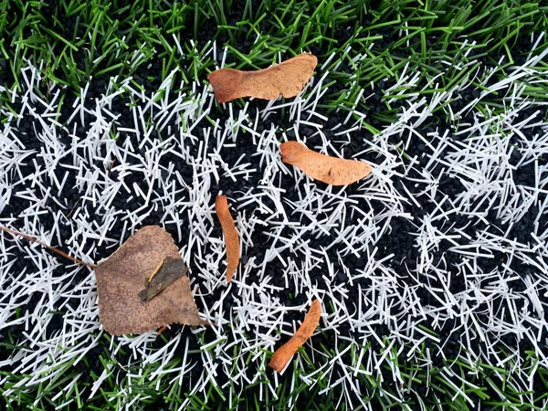 End of football season. Plastic green football turf — Stock Photo, Image