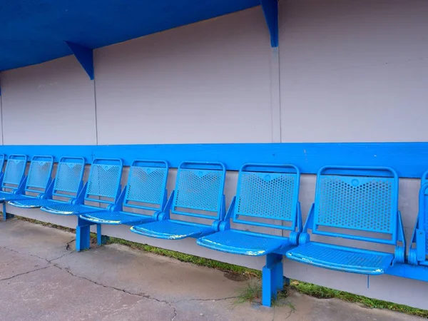 New blue metal seats on outdoor stadium players bench, — Stock Photo, Image