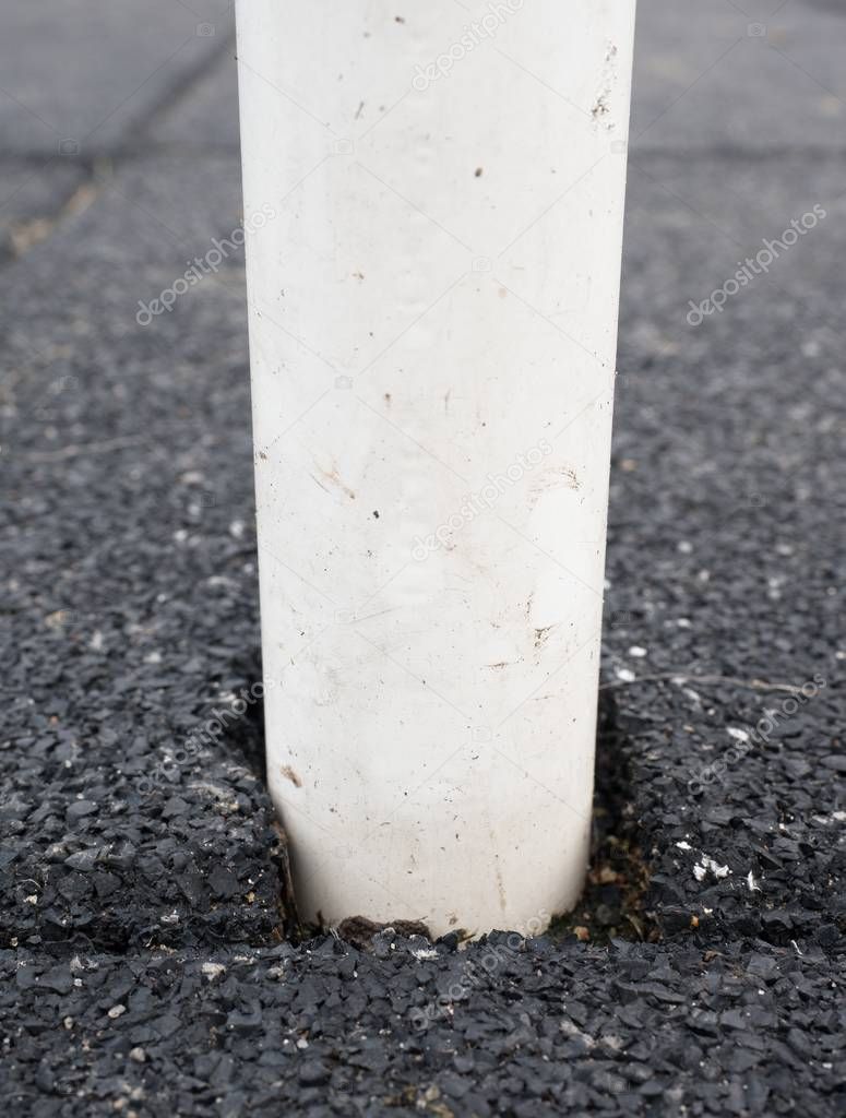 Pole in flexible tile for playground. Tiles made from a mixture of rubber crumb