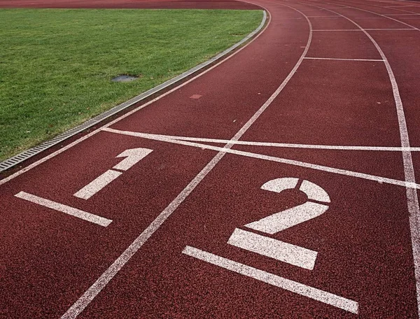 Número uno y número dos, pista de carreras de goma roja — Foto de Stock