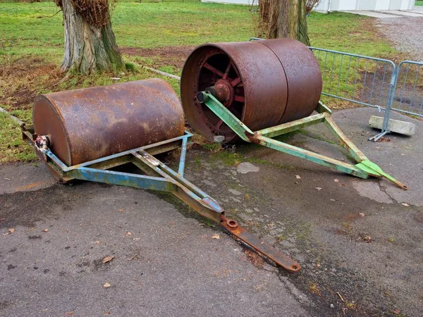 Old rusty iron barrel for maintenance of neglect tennis court.