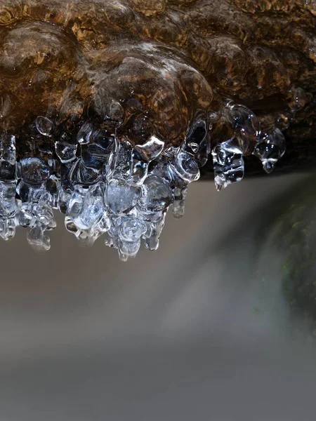 Icicles above freeze winter mountain stream. Winter season at river — Stock Photo, Image