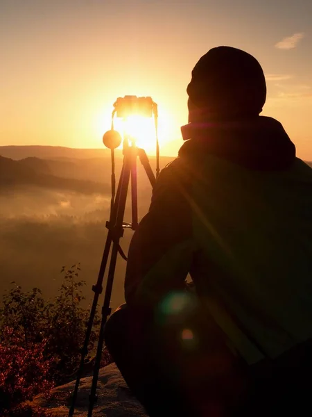 Fotograf auf dem Gipfel des Felsens. Herbst neblige Landschaft — Stockfoto