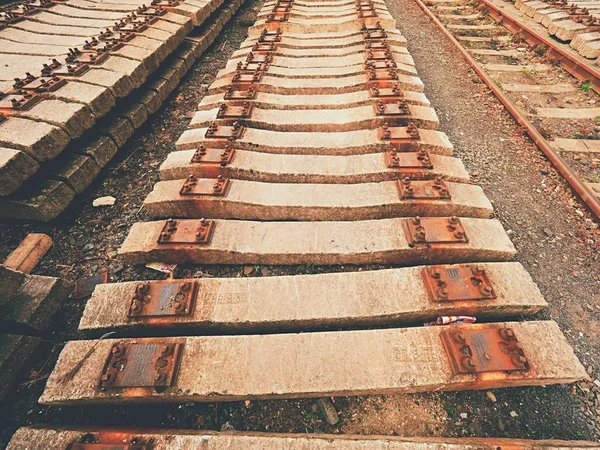 Dwarsliggers voorraad in railway depot gebruikt. Oud, vies en rusty gebruikt concrete spoorweg banden opgeslagen — Stockfoto