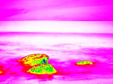 Infra. . Stony ocean beach with big boulders. Thermography effect. clipart