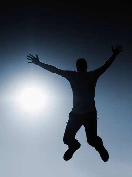 Man fly in air. Blue  Toned effect. Man falling down with hands up. — Stock Photo, Image