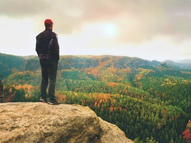 Turist Rehberi siyah. Uzun yürüyüşe çıkan kimse spor giyim ile Görünüm noktası sonbahar renkleri Vadisi üzerinde durmak. 