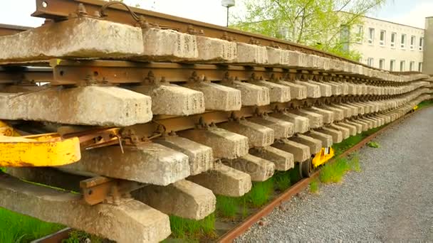 Used sleepers stock on wagon in depot. Old, dirty and rusty used concrete and wooden railway ties stored after reconstruction of railway station. Rails will transport to steel foundry for recycling — Stock Video