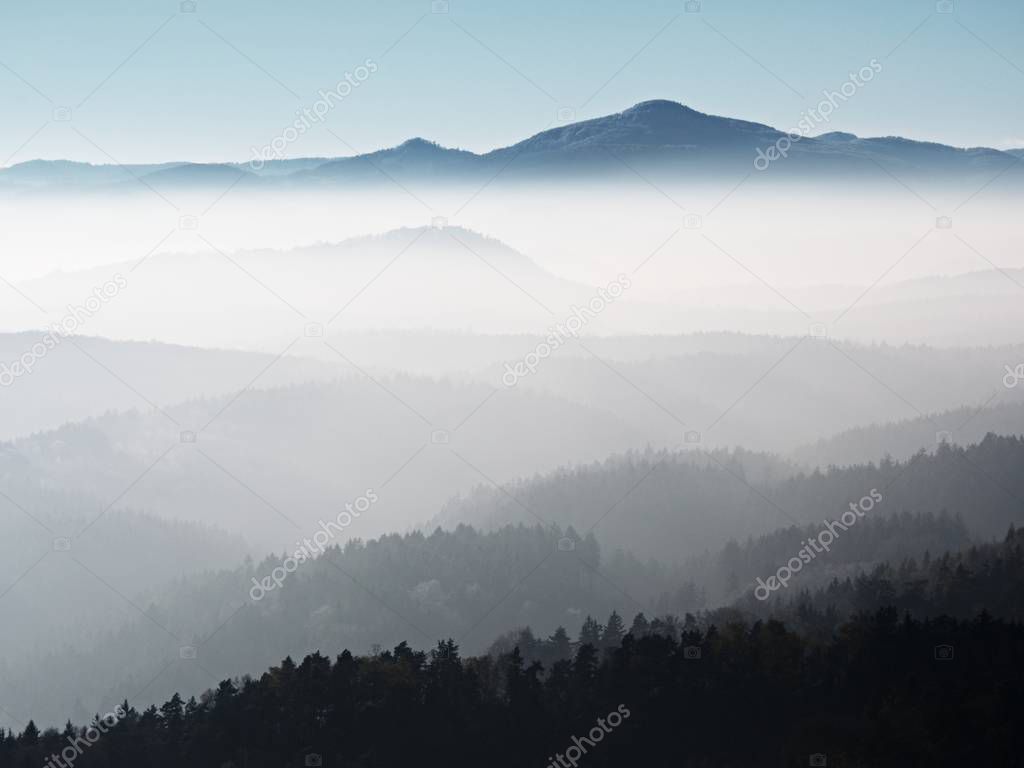 Scenic sunrise in the mountains, gradation of colorful mist