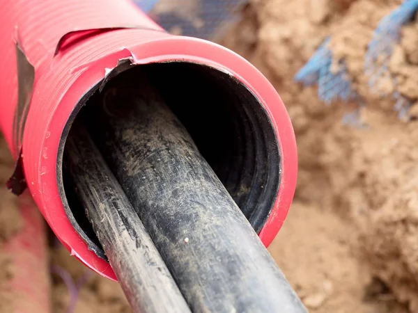 Wire in HDPE and protectivep tube. Building of lines of metallic and fiber optic cables, — Stock Image Wire in HDPE and protectivep tube. Building of lines of metallic and fiber optic cables, Royalty Free Stock Photos