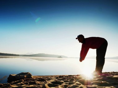 Derin nefes alma runner siluet elleriyle diz çöküyorum. Kas germe adama yan görünüm 