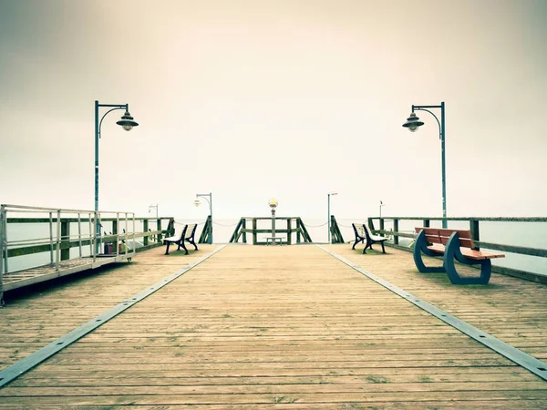 Seaside Telescope . Autumn misty morning on wooden pier — Stock Photo, Image