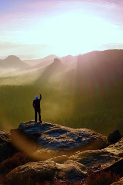 Adam akıllı telefon ile fotoğraf rock İmparatorluğu'nun peak alır. Rüya gibi adamlara manzara, Bahar turuncu bir güzel vadi Saksonya'nın İsviçre parkta.