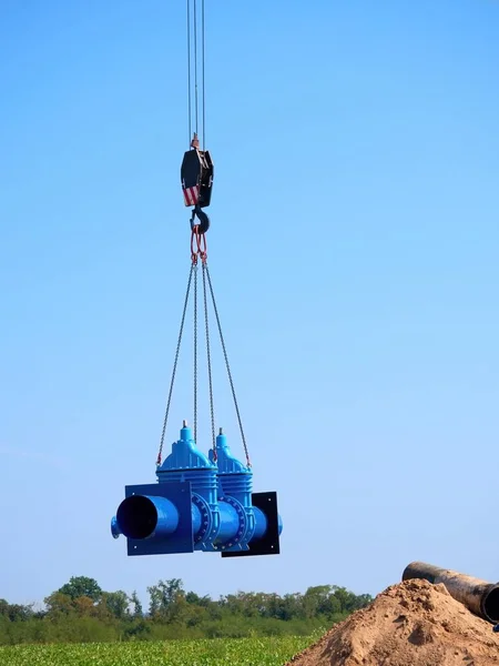 新しいゲート バルブと 500 mm のパイプラインを持つクレーンが動いています。飲み物水パイプラインの修復 — ストック写真