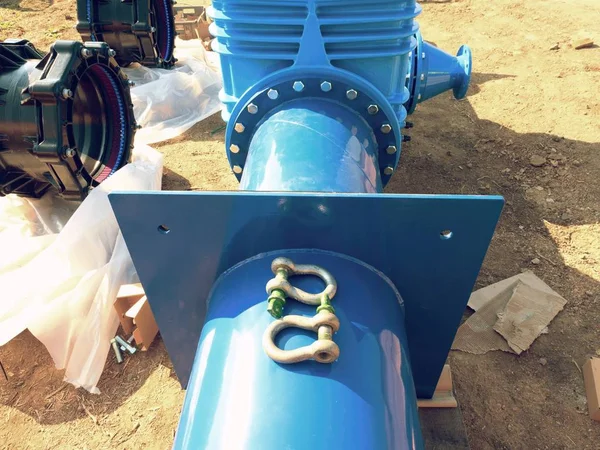 Big industrial gate valves in pipelines with big hand wheel. Repaired drink water pipeline in digged hole.