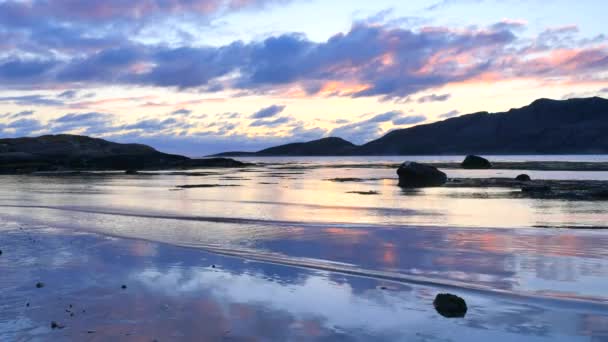 Захід сонця над гір над Північним морем. Воді водорості плавають на поверхні моря вечірня хвиля. Захоплюючий захід сонця на фоні гори на горизонті — стокове відео