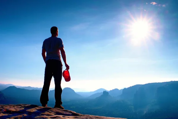 Turysta w Czerwonym Kapturku na szczyt skały w skale imperiów parku i oglądanie nad doliną mgliste i mgliste rano Sun. piękny podróż. — Zdjęcie stockowe