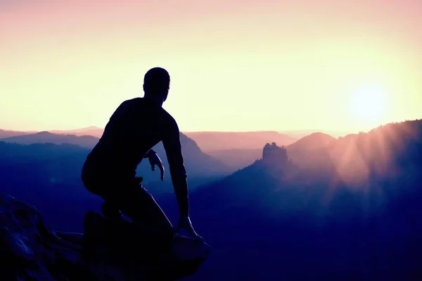 Alone male hiker in mountain landscape at sunset at horizon. Beautiful colorful mountain panorama in the evening in the mountains. — Stock Photo, Image