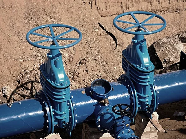 Gate valves underground, water pipeline valve on a blue pipeline after reconstruction.