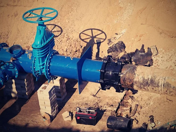 Gate valves underground, water pipeline valve on a blue pipeline after reconstruction.