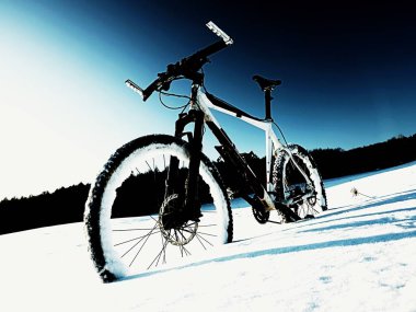 Extremme contrast. Mountain bike stay in powder snow. Lost path  in deep snowdrift.  clipart