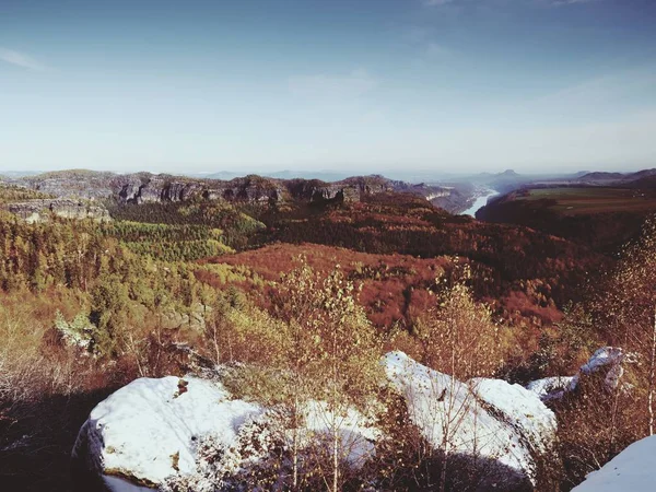 Första pulvret snötäcke på sandsten klippor ovan valley park. Tung dimma i dalen — Stockfoto